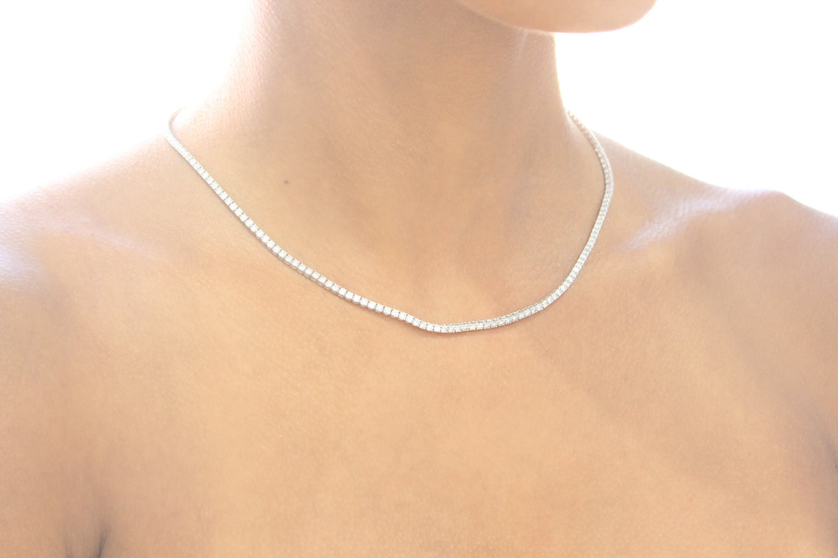 The Alaïa tennis necklace worn at the neckline