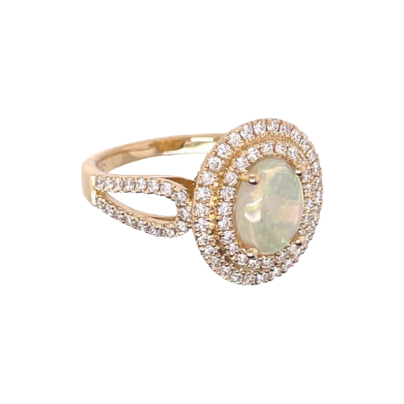 Yellow gold ring with an oval opal cabochon, double diamond halo and open, stone-set split shoulders.
