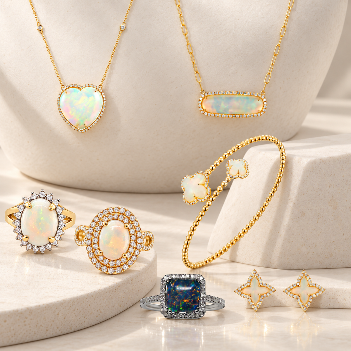 Gold heart and clover jewelry arranged on cream stone displays
